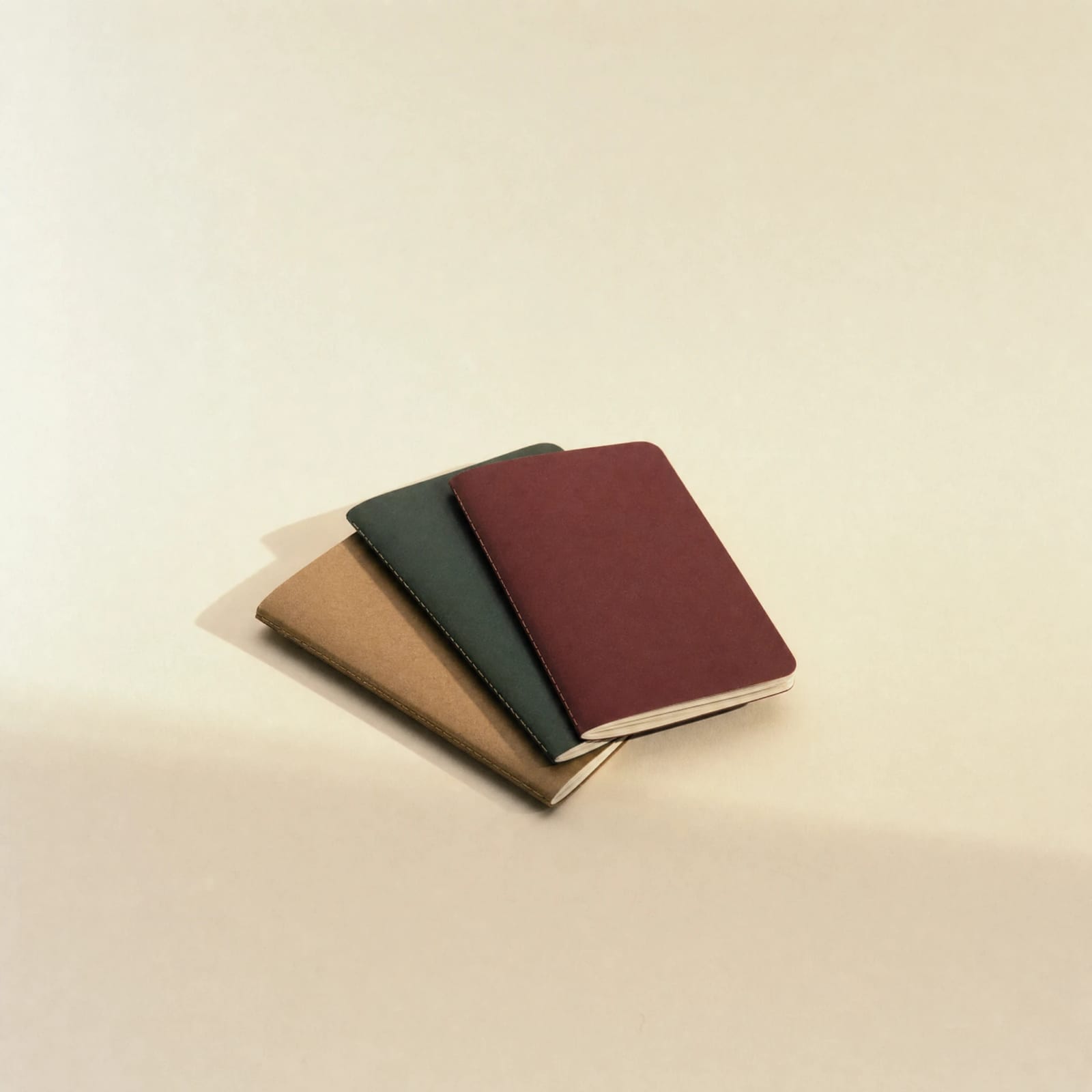No. 07 Field Notebooks — fanned stack in burgundy, forest green, and kraft